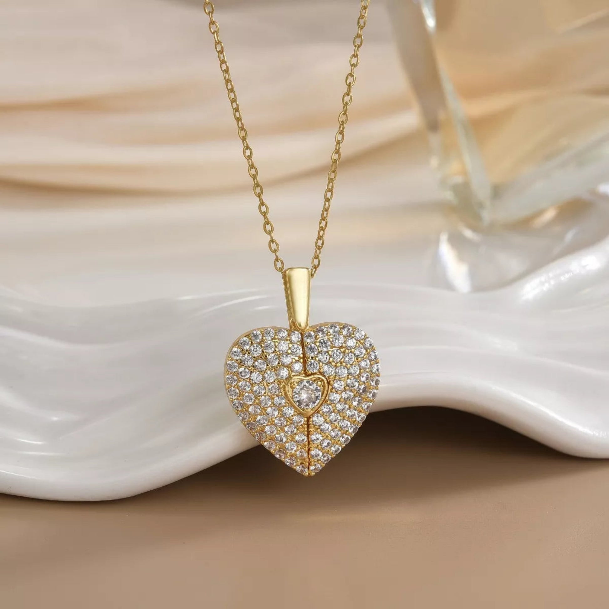 Close-up gold heart locket necklace with sparkle detail